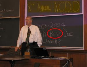 William "Bubba" Head presenting at the National College for DUI Defense conference with "Best DUI Lawyer?" written on the chalkboard